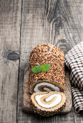 Sponge cake roll isolated on wooden rustic table
