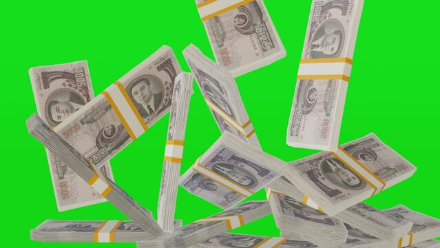 Many wads of money falling on chromakey background. 5000 North Korean Won banknotes. Stacks of money. Financial and business concept. Green screen.	
