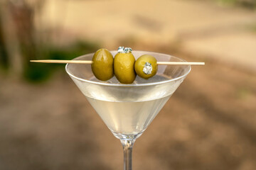 Dirty martini with green olives and blue cheese, vodka mixed alcoholic drink