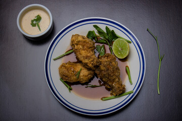 chicken pieces with herbs and lemon around