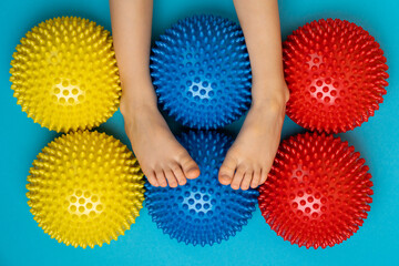 children's feet with a colored balancer on a light blue background, treatment and prevention of...
