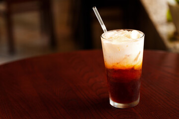 Thai iced coffee in a cafe on a dark table with coffee space