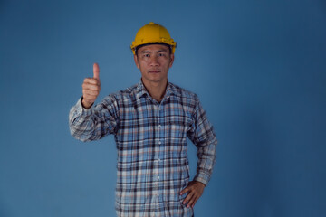 Worker portraits with the yellow hat. blue color background.
