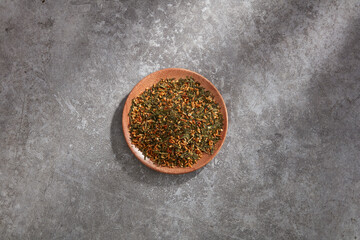 Top view of barley tea decorated in wooden dish and cement background 