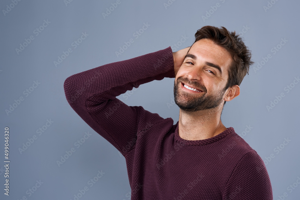 Poster handsomeness that just cant be ignored. studio shot of a handsome and happy young man posing against