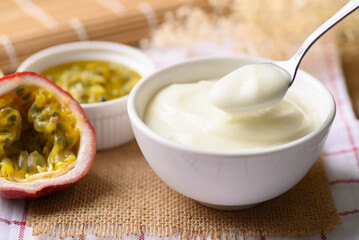 Yogurt with spoon in bowl and passion fruit, Healthy eating