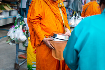 Fototapeta na wymiar Thai monk ask for alms for buddhist to make merit
