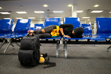 Airport Terminal Beautiful  Lying Down for a Rest and Sleep while Waiting for Vacation Flight.