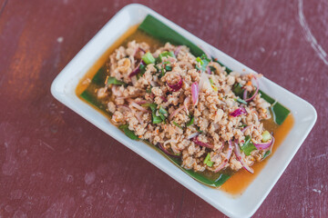 spicy minced pork salad on table