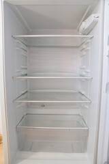 empty shelves of the open refrigerator. household appliances 