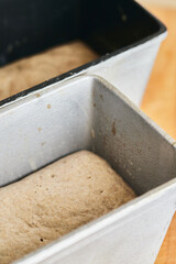 The process of making rye bread. The dough on the rye bread is laid out in a mold. Vertical photo.
