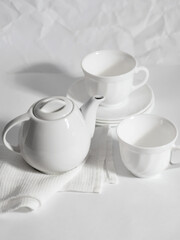 minimalistic white porcelain teapot and cups for tea drinking for two