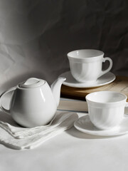 minimalistic white porcelain teapot and cups for tea drinking for two