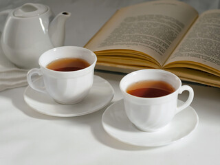 minimalistic white porcelain teapot and cups for tea drinking for two
