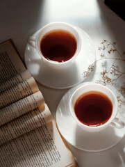 minimalistic white porcelain teapot and cups for tea drinking for two