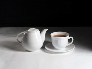 minimalistic white porcelain teapot and cups for tea drinking for two