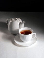 minimalistic white porcelain teapot and cups for tea drinking for two