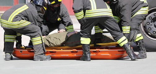firefightes and a injured person on the stretcher
