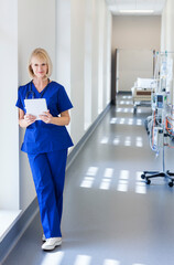 Caucasian female healthcare staff working on tablet technology in medical centre