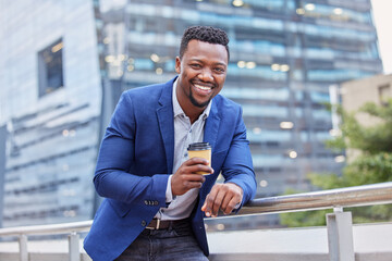 Just the boost I needed. Shot of a young businessman drinking a cup of coffee against a city background.