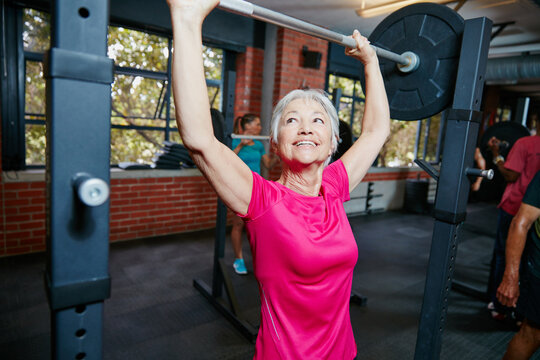 Im like nothing youve ever seen before. Shot of a senior woman lifting weights at the gym.