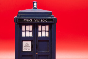 Police call box isolated on red background. Tardis from Doctor Who.