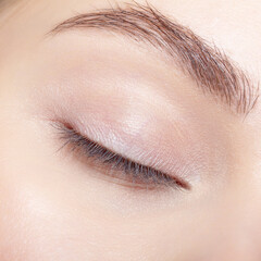 Closeup macro shot of human  female closed eye with nude makeop.