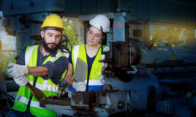 A team of professional male and female engineers with quality skills, inspecting, controlling, and maintaining machines