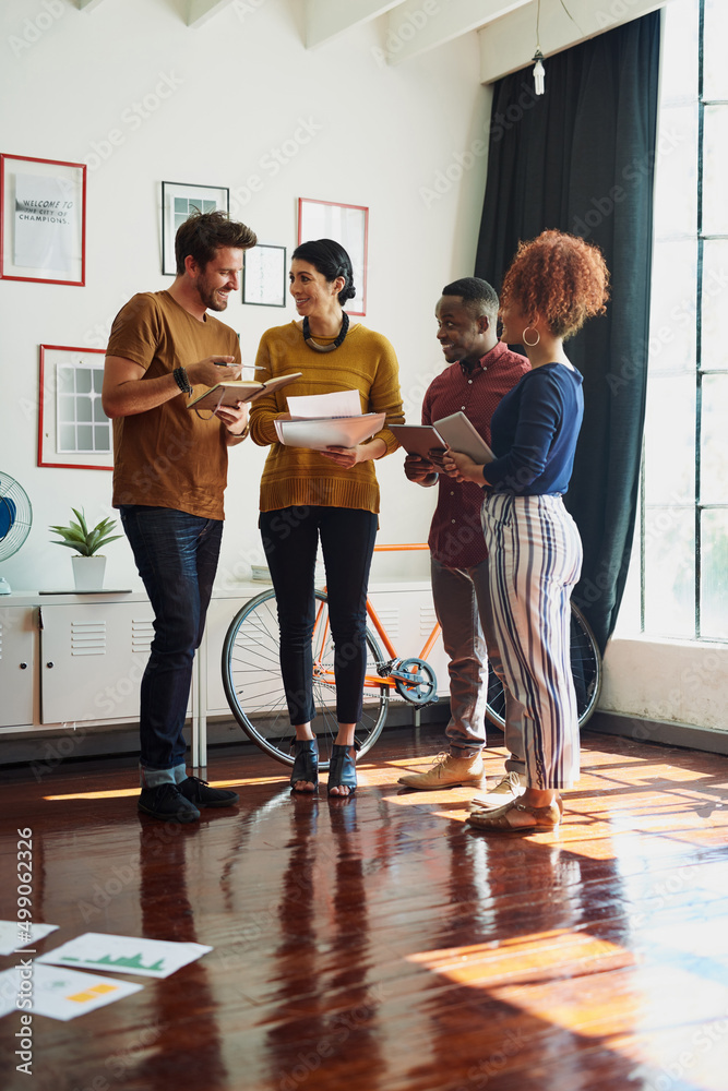 Poster Working together brings out the best in them. Shot of a group of creative workers having a brainstorming session in an office.