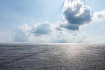 Asphalt road platform and beautiful blue sky with white clouds scene. Road and sky cloud background.
