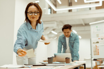 Busy man and woman with a new project in a co-working space