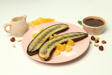 Concept of tasty food with grilled banana on white background