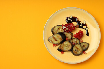 Concept of tasty food with grilled banana on orange background