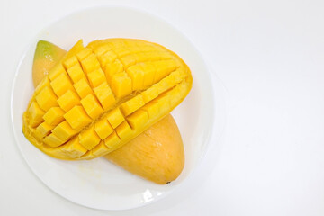 Top view of fresh juicy Mango sliced on a white dish