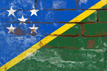 Distressed old solomon islands flag on a concrete wall surface