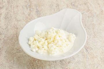 Grained cottage cheese in the bowl
