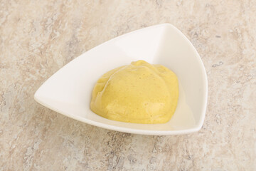 Organic mustard sauce in the bowl