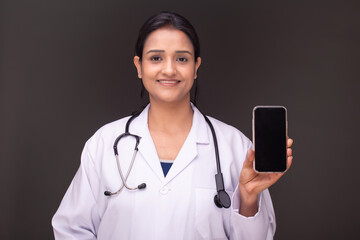 young doctor woman showing blank screen of smartphone 