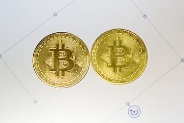 Bitcoin coins on square tiles rendered with pixels on computer screen. The concept of...