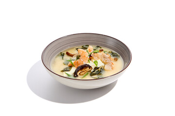 Japanese food - miso soup with tofu, wakame, prawn and shiitake mushroom. Miso soup with shrimp in ceramic bowl on isolated white background.