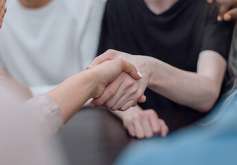 close up. handshake of young people during a group meeting