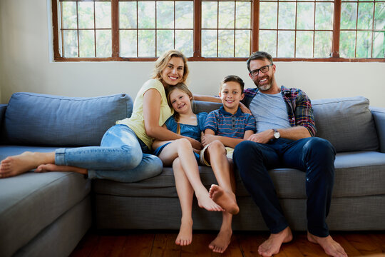 What We Love To Do, Chilling Together Comfy And Caring. Shot Of An Affectionate Family On The Sofa In The Living Room At Home.