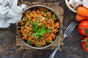 Green lentils stew with white wine, Serrano ham and smoked paprika