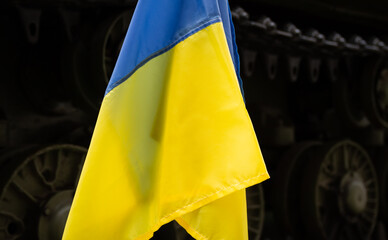 National flag of Ukraine, with battle tank in background. Protest manifestation against Russia...