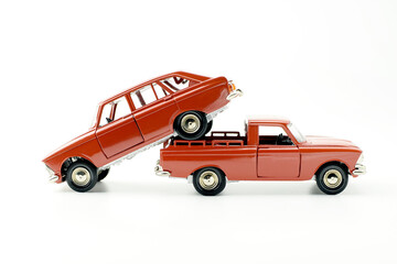 Light truck carrying a car. Two red cars, isolated on white.