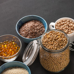 Source of vitamin E and nutrients in bowls on the table, copy space