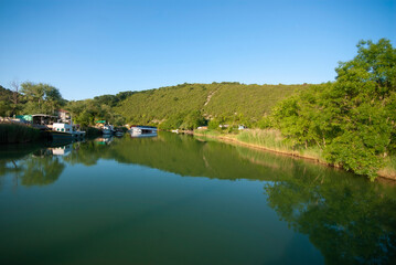 Obraz premium Boat ride on the calm river. It is a popular place and holiday destination on the Göksu river. Reflection of trees. Reflections in the water. Agva, Sile, Istanbul, Turkey.