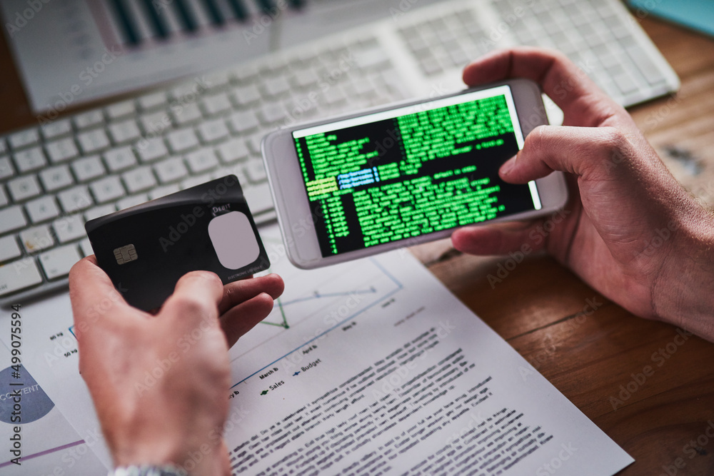 Leinwandbilder Setting up state of the art security features. Shot of an unidentifiable programmer holding his credit card while programming on his smartphone.