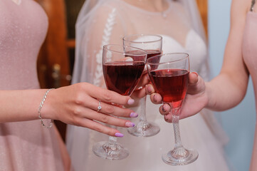 Glasses of red sparkling wine in girls hands. The concept of party and celebration