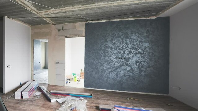 Interior design of new stylish apartment in white and gray tones with wooden elements, before and after overhaul. Gradual creation of cozy home from empty concrete walls to ready to live flat.